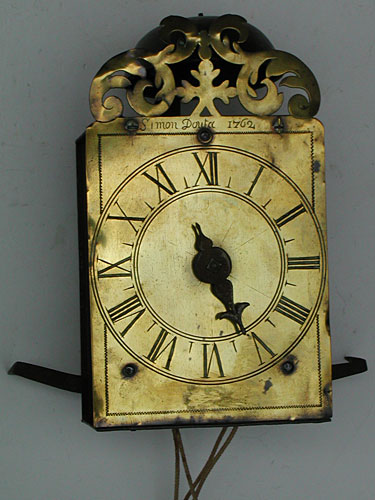tiny single-handed hook-and-spike wall clock made in 1762 by Simon Douta